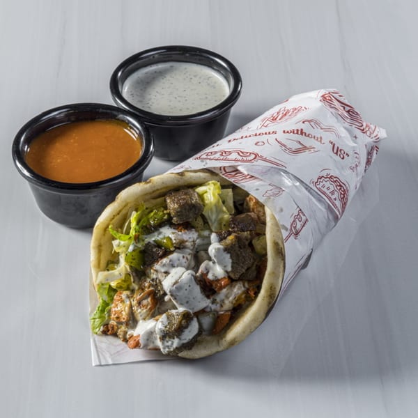 Blazing Hot Halal Grill's chicken and lamb gyro with white sauce, red sauce, and lettuce.